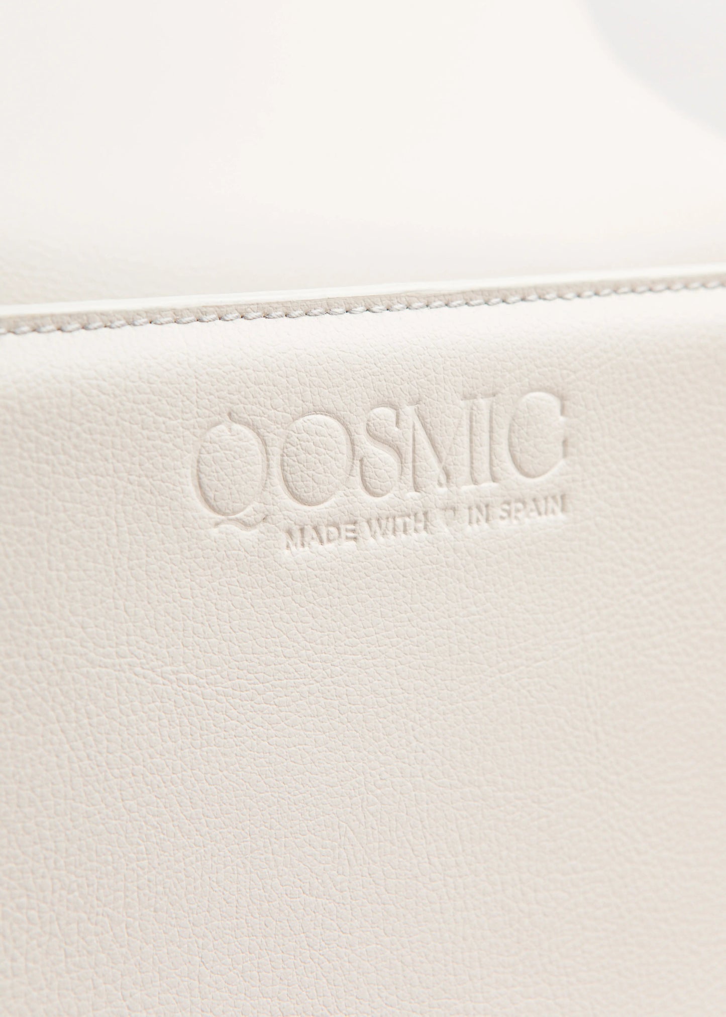 Qosmic Oberon Moonstone - cream bag - logo detail