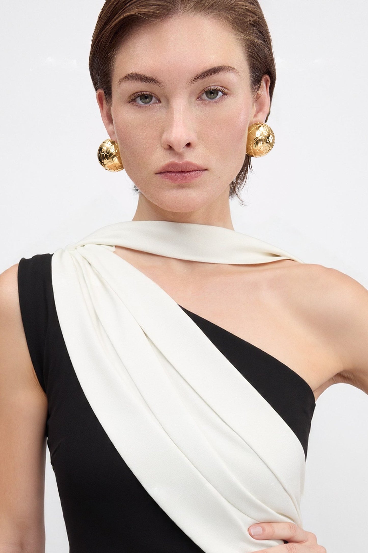 Formal flared dress with asymmetric neck and back sash design.